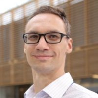 a person wearing glasses and a tie