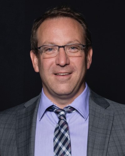 a person in a suit and tie smiling