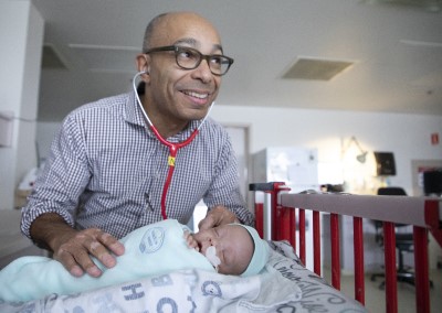 a person in a hospital room with a baby