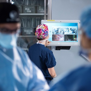 a group of surgeons in scrubs watching a patient