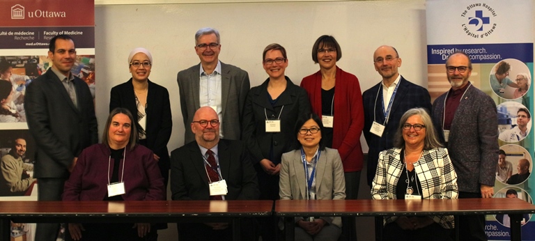 a group of people standing around a table