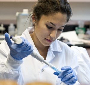 a person in a lab coat and gloves