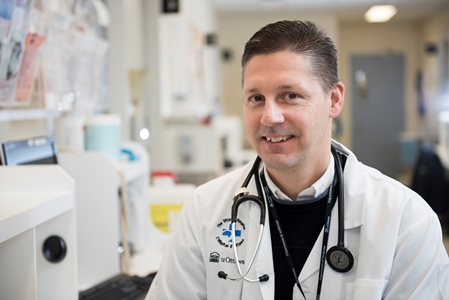 a person in a white coat sitting at a desk