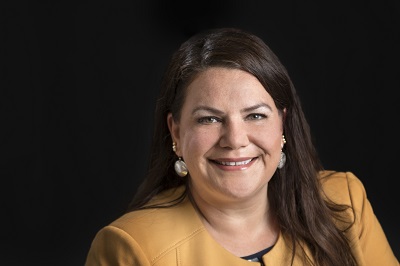 a person in a yellow jacket and black shirt