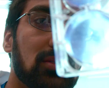 a person holding a glass with a liquid inside