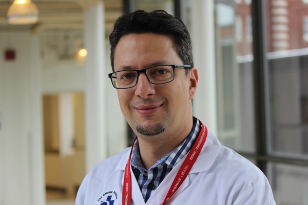 a person in a white lab coat and glasses