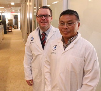 two people standing in a hallway