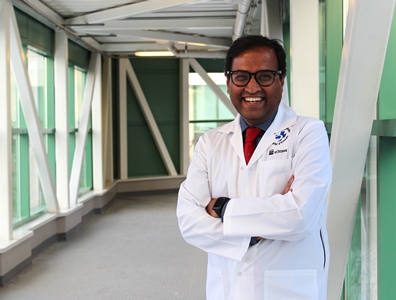 a person in a lab coat standing in a hallway