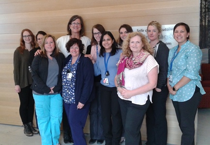 a group of people standing in front of a wall