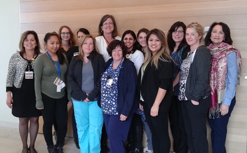 a group of people standing in front of a wall