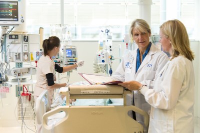 a group of people in a hospital room
