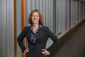 a person standing in a hallway with their hands on their hips