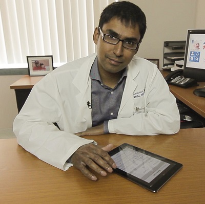 a person sitting at a desk with a tablet