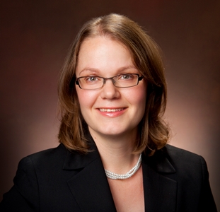 a person wearing glasses and a black jacket