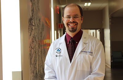 a person in a lab coat standing in a hallway