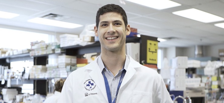 a person in a lab coat standing in front of a counter