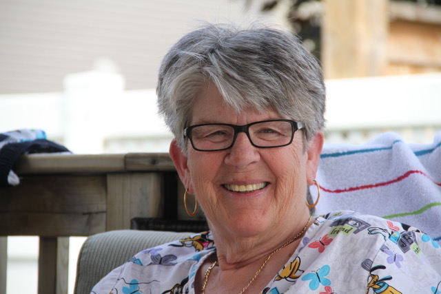 a person with glasses sitting on a chair