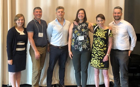 Group of people standing in front of a curtain