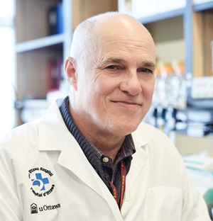 a person in a lab coat sitting at a table