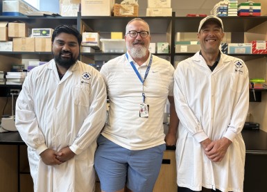 three people in lab coats