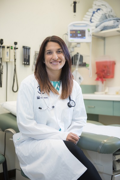 a person in a white lab coat sitting on a chair