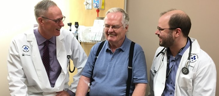 three people in a hospital exam room