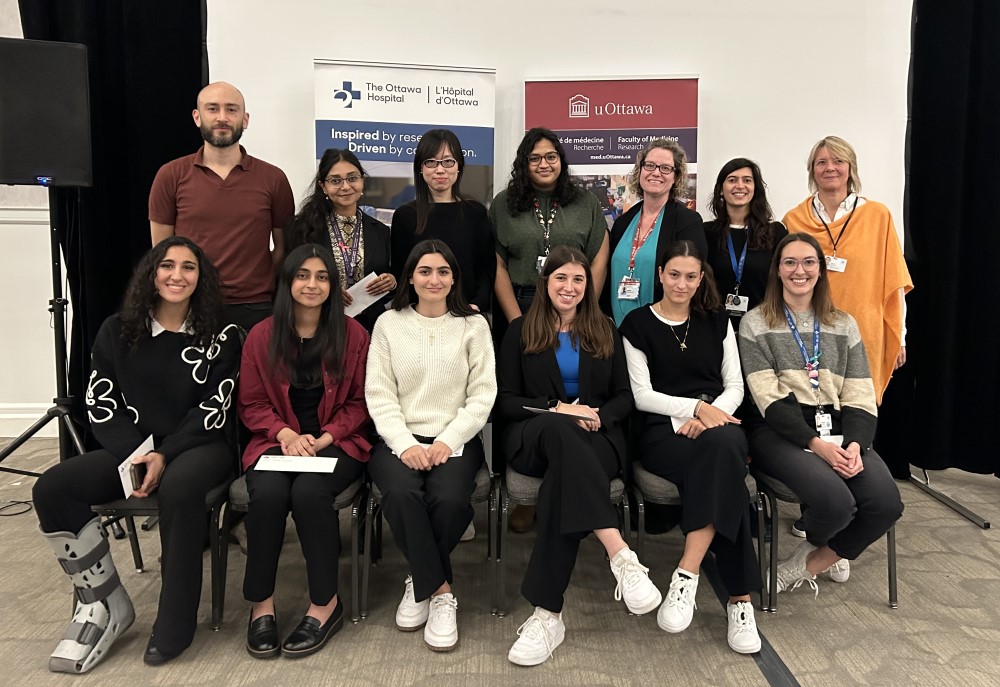 a group of people sitting in chairs in front of a banner
