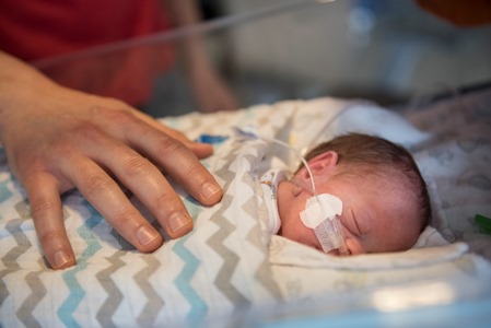a baby is being held by a nurse