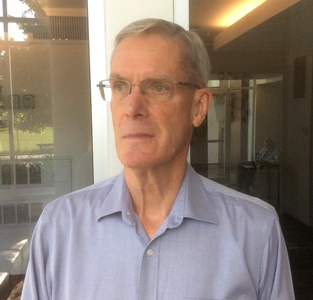 a person in a blue shirt and glasses