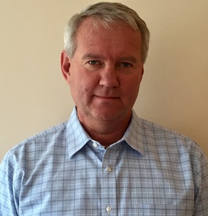 a man standing in front of a wall