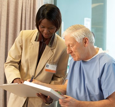 a nurse and patient looking at a clipboard
