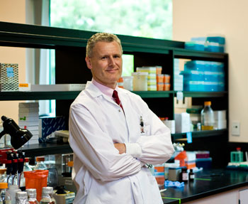 a person in a lab coat standing in a lab