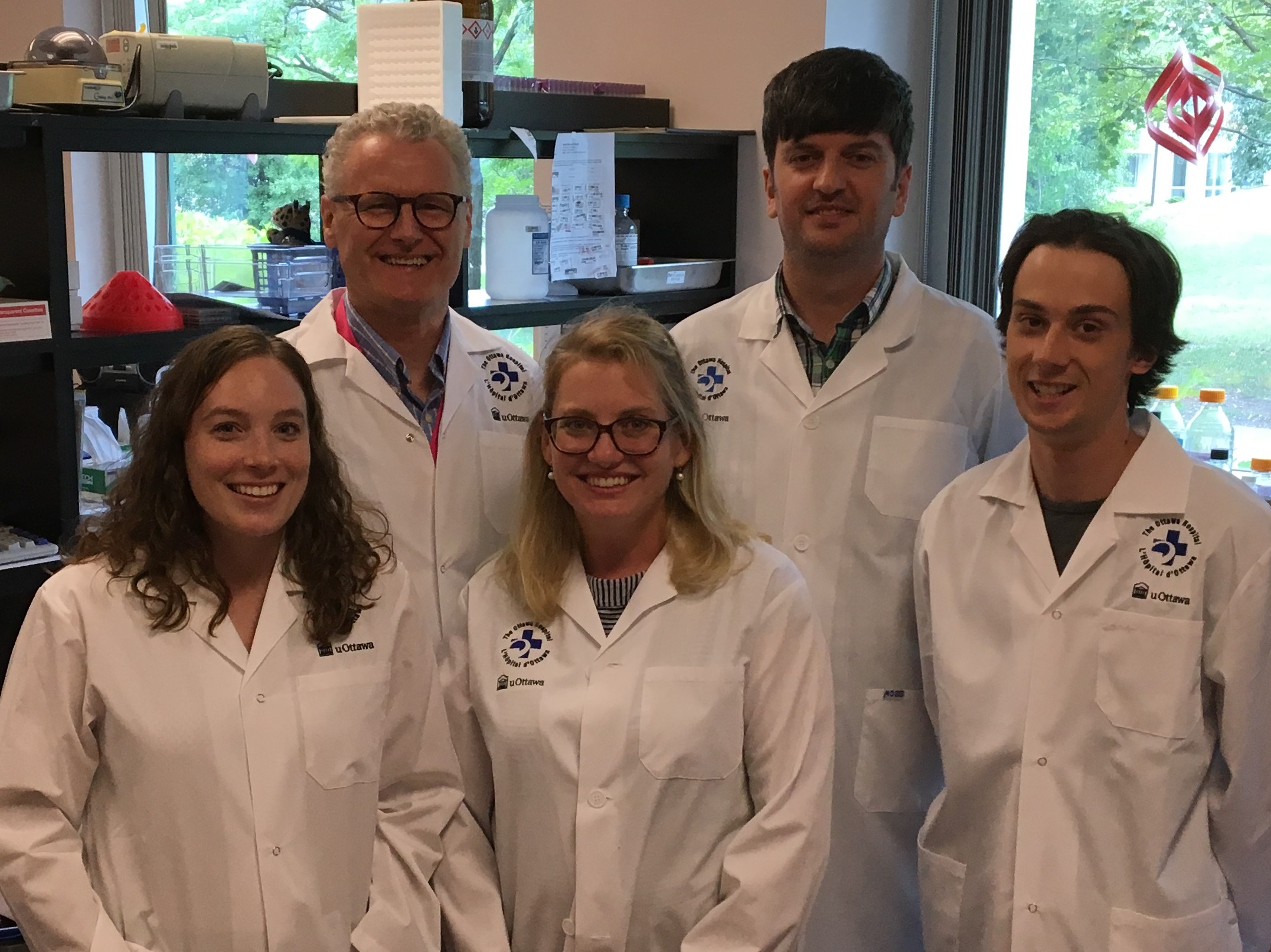 a group of people standing in a lab
