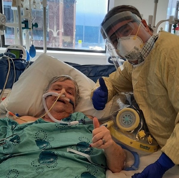 a person in a hospital bed with a mask on