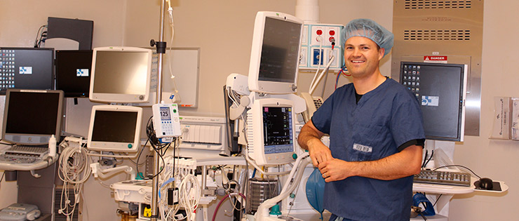 a person in a hospital room with a monitor