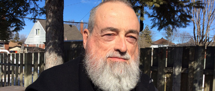 a person with a long beard and a black sweater