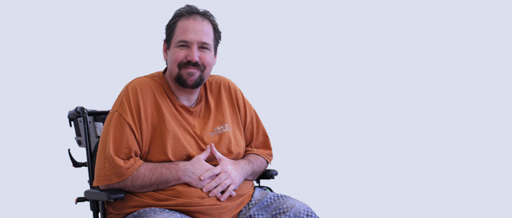 a person in a wheelchair with their hands folded