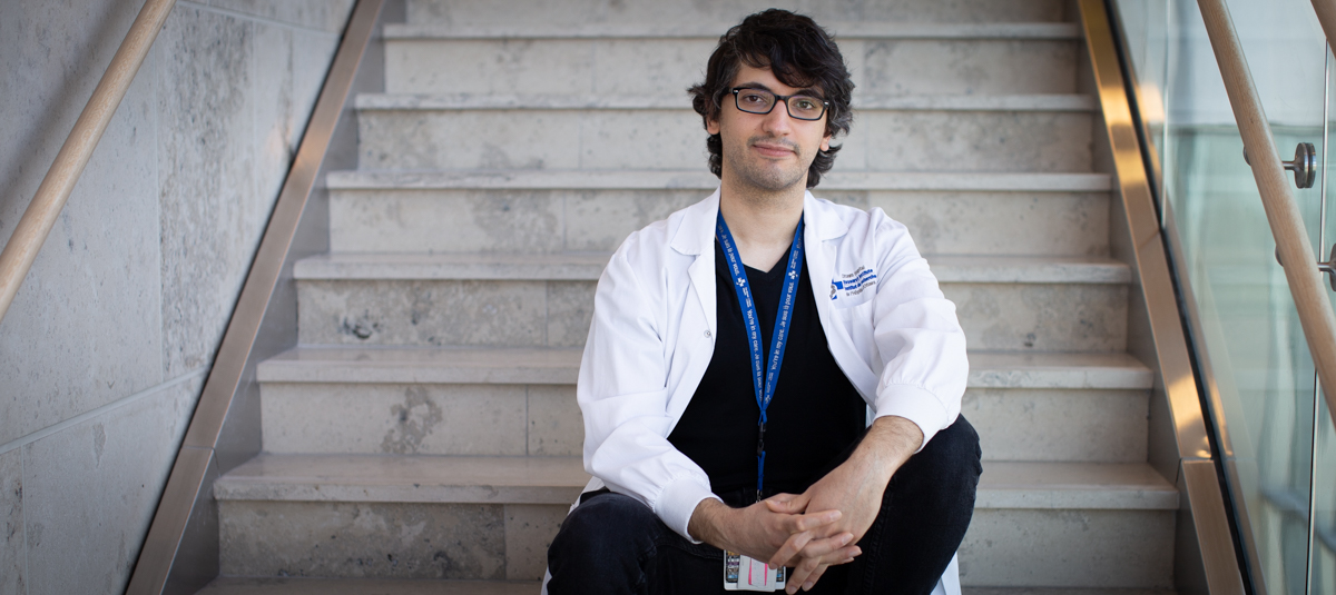 a person sitting on the stairs of a building