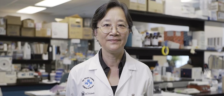 a person in a lab coat standing in front of a shelf