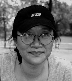 a person sitting on a bench in a park
