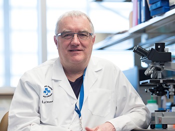 a person in a lab sitting at a table