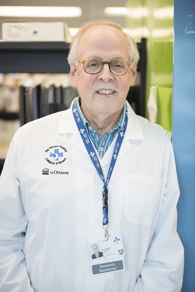 a person in a lab coat standing next to a blue wall