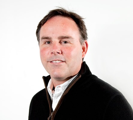 a person in a black sweater standing against a white background