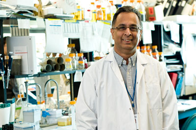 a person in a lab coat standing in front of a desk