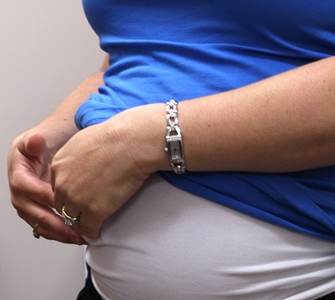 a person in a blue shirt holding their stomach