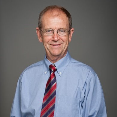 a person in a blue shirt and tie