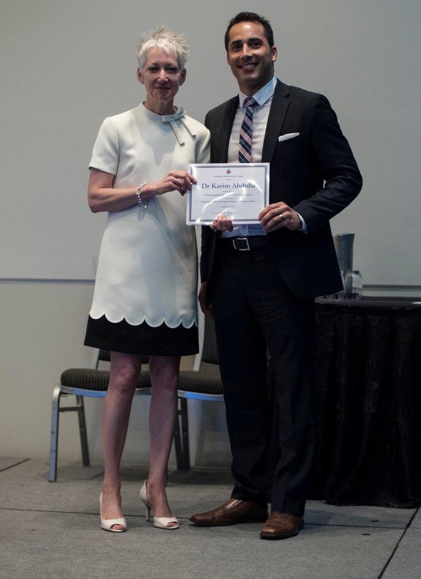 one person presenting an certificate/award to another person