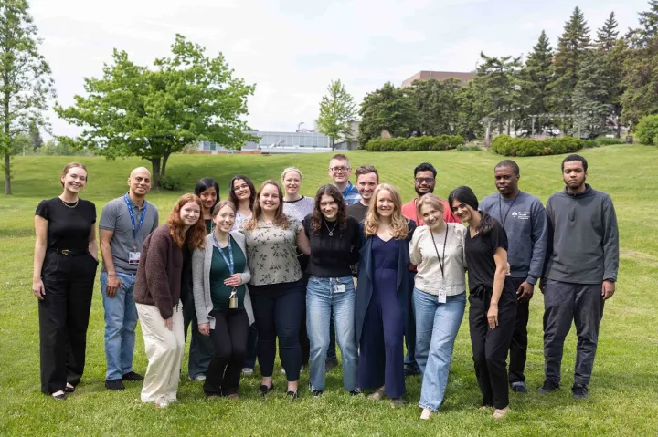 Members of the Blueprint team standing on grass with trees in the background