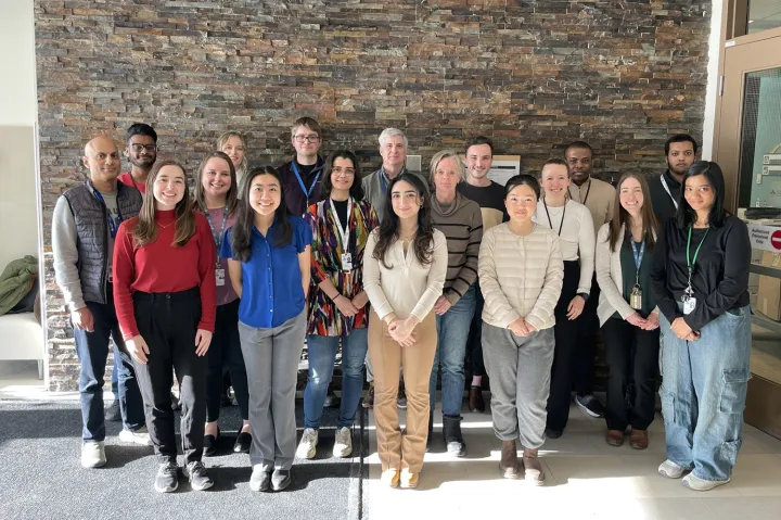 Members of the Blueprint team standing in front of a brick wall