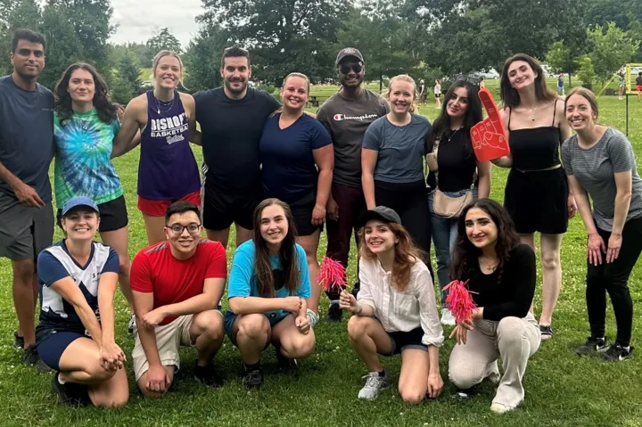 Members of the Blueprint team on a grassy lawn with trees in the background